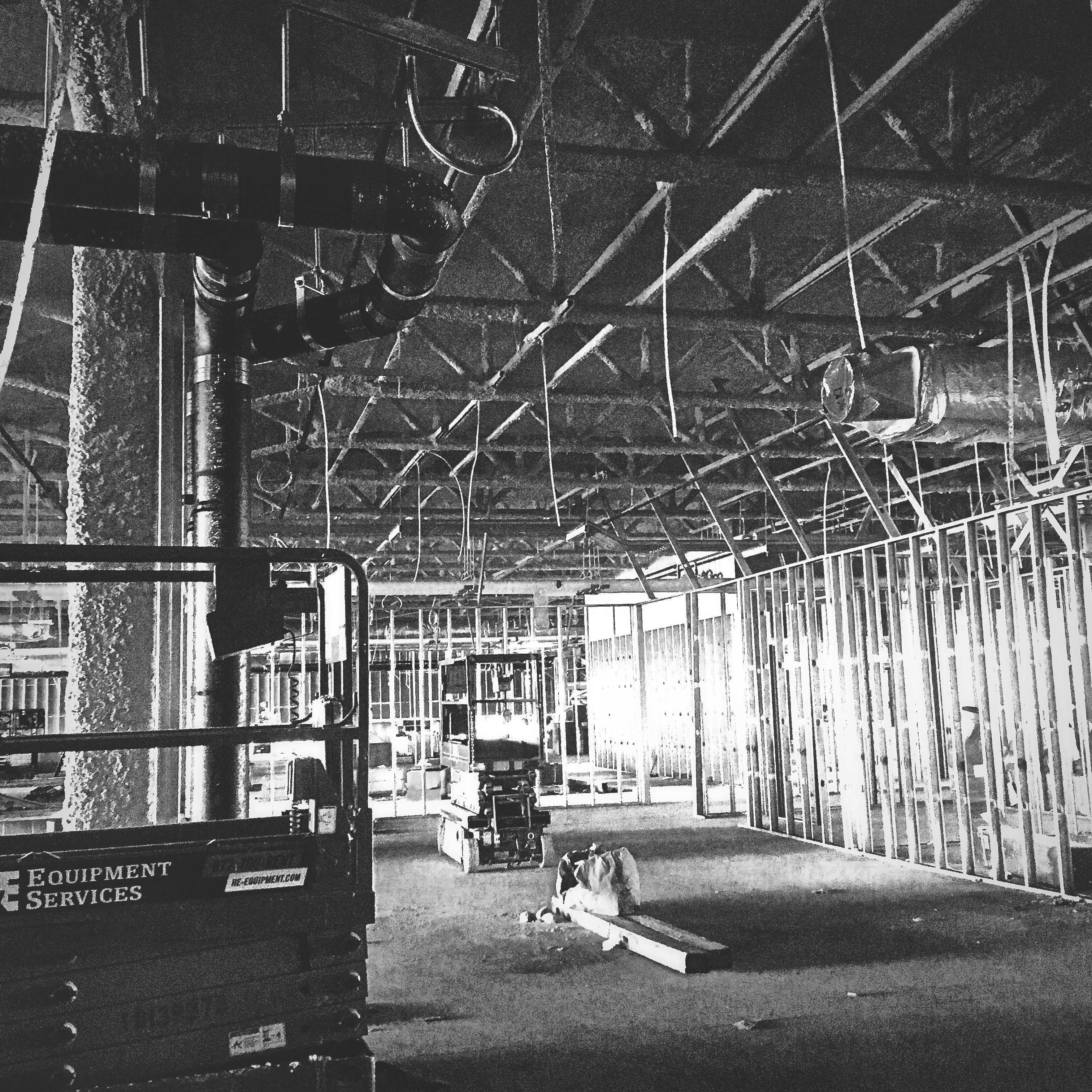 Construction site viewed at scale — the crane and the crew that outsiders cannot see the work of from a distance